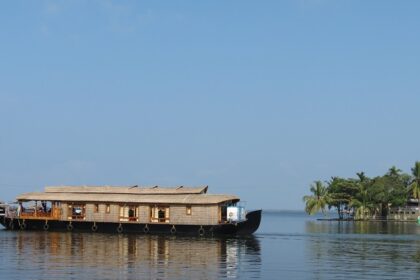 Houseboat on the picturesque backwater of Kerala with a backdrop of Coconut trees