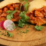 A round food platter is served on the table, which consists of a variety of dishes.