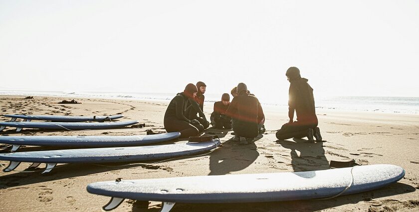 A picture of a vibrant crowd of people amidst Chivla Beach indulging in diverse water sports.