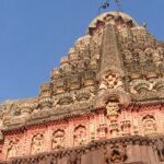 An image of the Grishneshwar Temple, surrounded by lush greenery and historical landmarks.