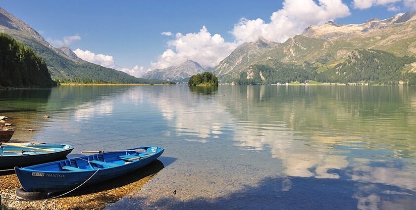 An image view of Sils lake in Switzerland with clear blue waters, mountains, and a scenic landscape